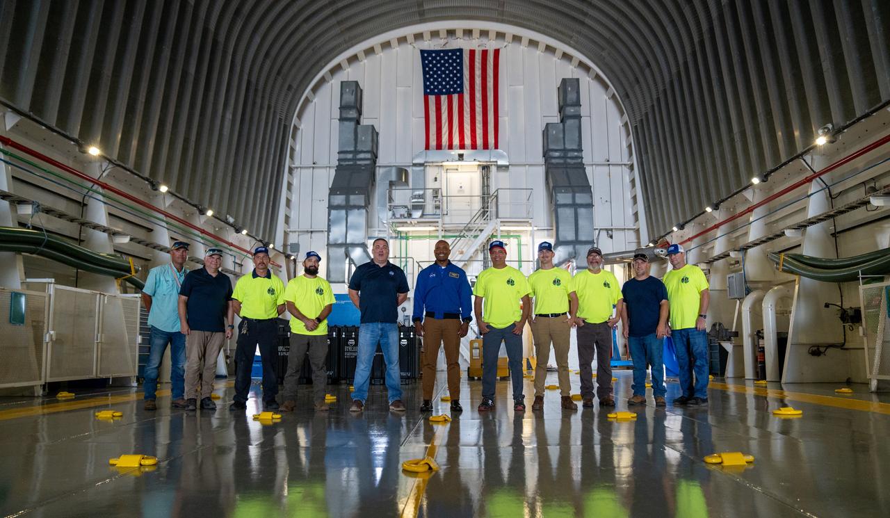 NASA astronaut Victor Glover views the core stage of the SLS (Space Launch System) rocket that will help power Artemis II at NASA’s Michoud Assembly Facility in New Orleans July 15. Glover will pilot Artemis II, the first crewed mission of NASA’s Artemis campaign. Crews moved the 212-foot-tall core stage with its four RS-25 engines to Building 110 at NASA Michoud prior to rolling it out to NASA’s Pegasus barge July 16 for delivery to NASA’s Kennedy Space Center in Florida. The core stage has two giant propellant tanks that collectively hold more than 733,000 gallons of super cold liquid propellant to feed the stage’s four RS-25 engines. Together, the engines produce more than 2 million pounds of thrust to help send astronauts inside NASA’s Orion spacecraft to venture around the Moon for Artemis II.  NASA is working to land the first woman, first person of color, and its first international partner astronaut on the Moon under Artemis. SLS is part of NASA’s backbone for deep space exploration, along with the Orion spacecraft, supporting ground systems, advanced spacesuits and rovers, the Gateway in orbit around the Moon, and commercial human landing systems. SLS is the only rocket that can send Orion, astronauts, and supplies to the Moon in a single launch.  